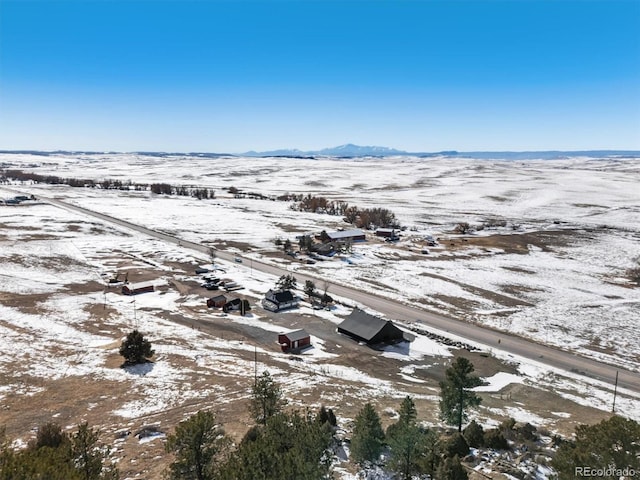 snowy aerial view with a mountain view