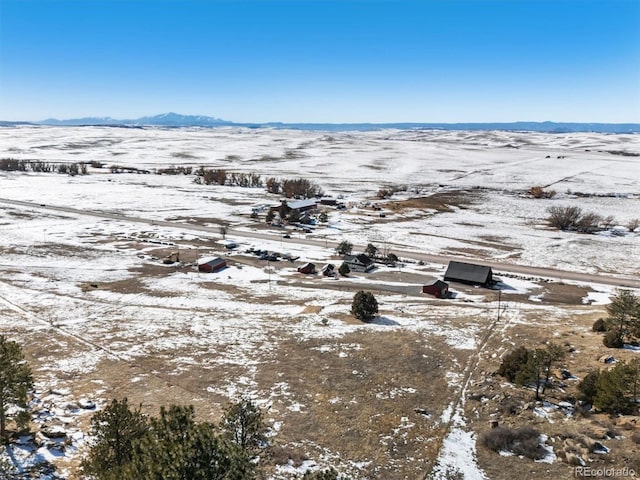 snowy aerial view featuring a mountain view