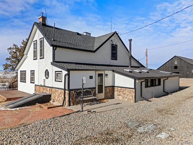 rear view of property featuring a deck