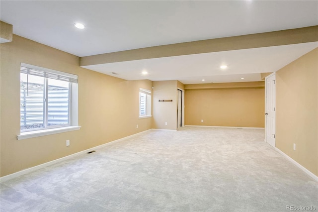 basement with light colored carpet and plenty of natural light