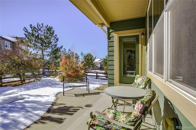 view of snow covered back of property