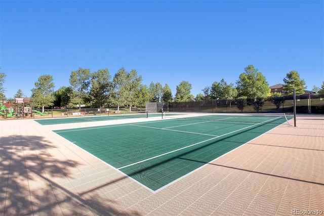 view of sport court featuring a playground