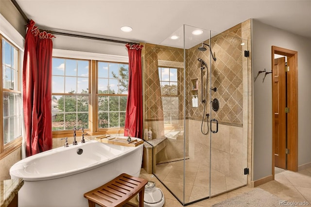 11535 E Powers Ave, Englewood, CO 80111 - full bath with a soaking tub, a stall shower, tile patterned flooring, and recessed lighting