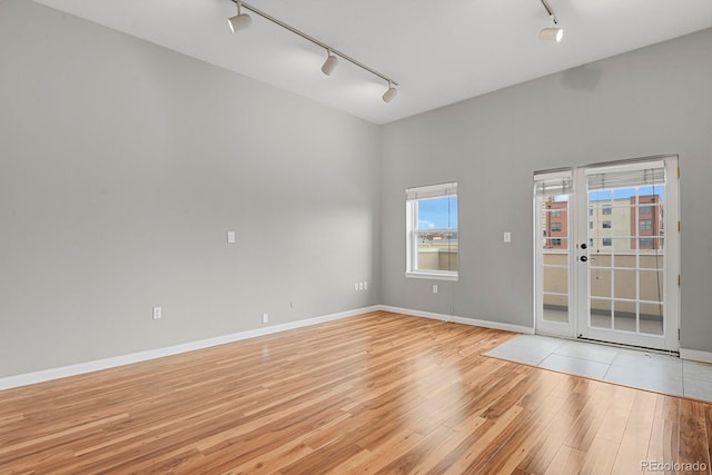 1780 N Washington St Unit 405, Denver, CO 80203 - unfurnished room with rail lighting, light wood-style flooring, and baseboards