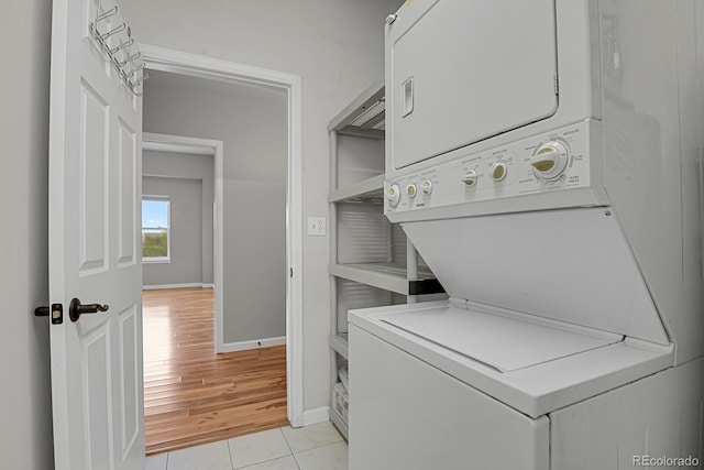 1780 N Washington St Unit 405, Denver, CO 80203 - washroom with stacked washer / drying machine, baseboards, and light wood-style flooring