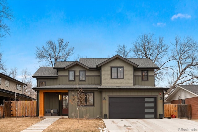 view of front of house featuring board and batten siding, driveway, an attached garage, roof with shingles, and fence