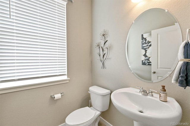 bathroom featuring toilet and sink