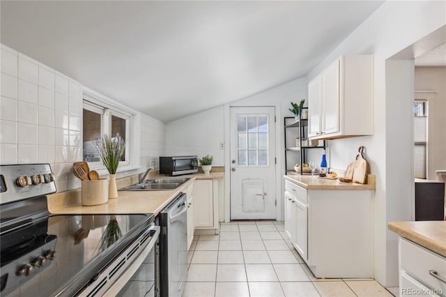 kitchen with sink, a wealth of natural light, white cabinets, and appliances with stainless steel finishes