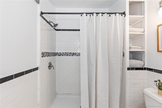 bathroom with toilet, tile walls, and walk in shower