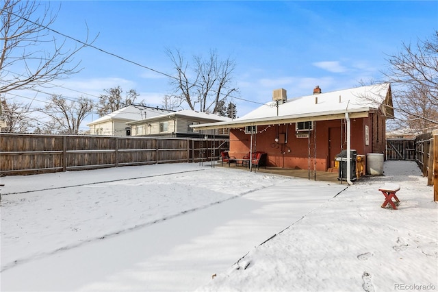 view of snow covered rear of property