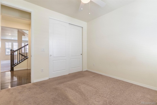 unfurnished bedroom featuring ceiling fan, carpet, and a closet