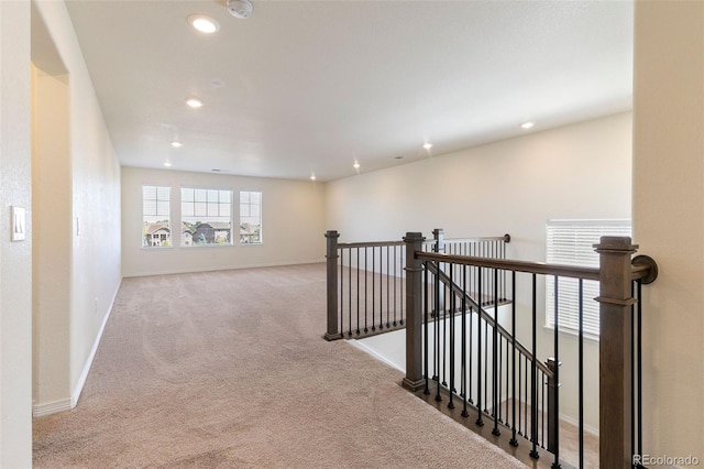 corridor featuring light colored carpet