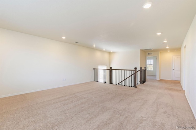 spare room with light colored carpet