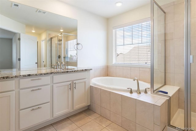 bathroom featuring tile patterned floors, independent shower and bath, and vanity