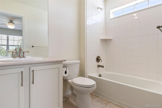 full bathroom featuring toilet, vanity, tile patterned flooring, tiled shower / bath, and ceiling fan