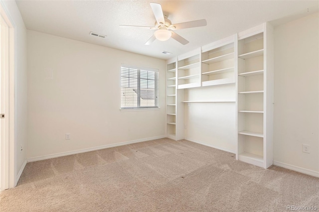 unfurnished bedroom with ceiling fan and light carpet