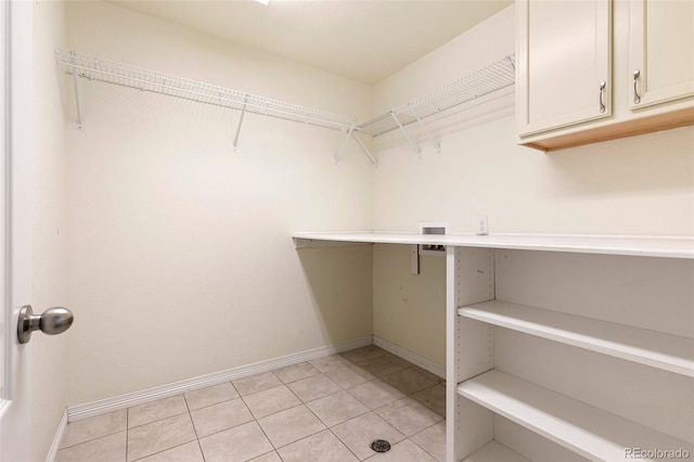 spacious closet with light tile patterned floors