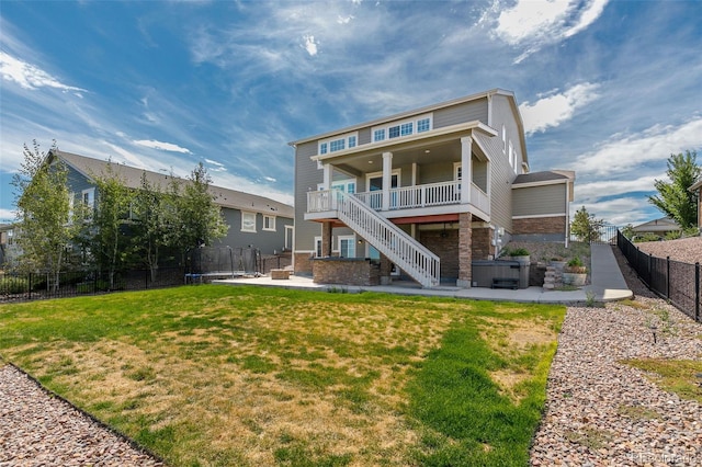 rear view of property featuring a patio and a yard