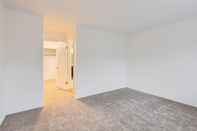 carpeted empty room with baseboards