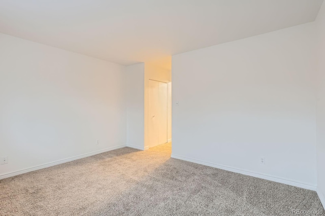 carpeted spare room with baseboards