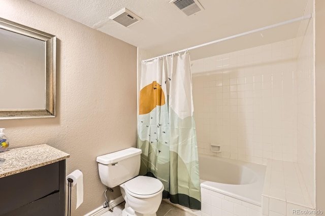 bathroom featuring toilet, vanity, visible vents, and a textured wall
