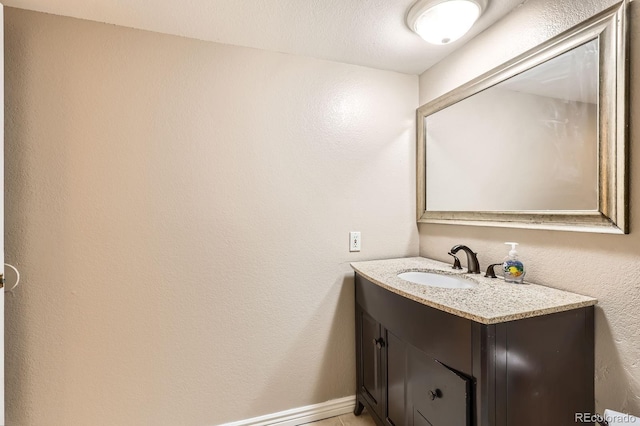 bathroom with baseboards and vanity