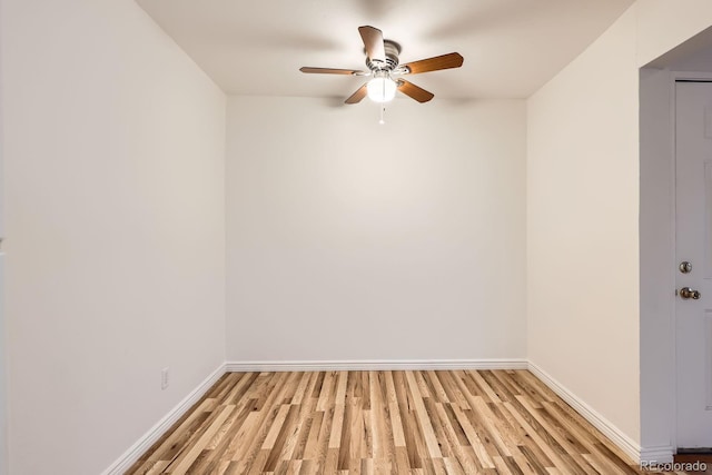 empty room with baseboards, ceiling fan, and light wood-type flooring