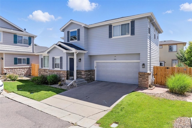 10116 Wyandott Cir, Denver, CO 80260 - view of front of house featuring driveway, an attached garage, and brick siding