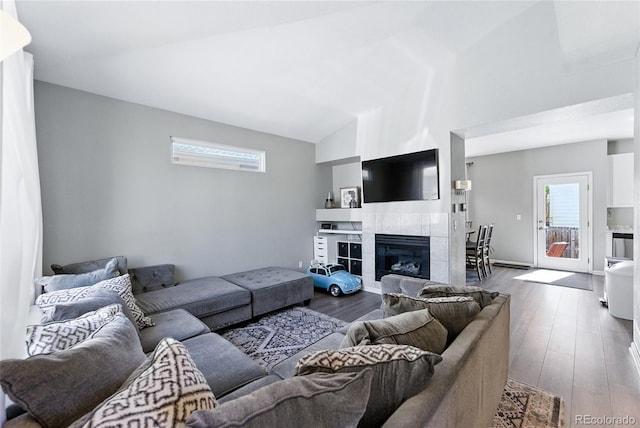 10116 Wyandott Cir, Denver, CO 80260 - living room with wood finished floors, a tiled fireplace, and vaulted ceiling