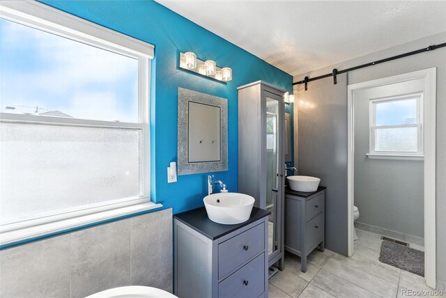 10116 Wyandott Cir, Denver, CO 80260 - bathroom with two vanities and tile patterned flooring
