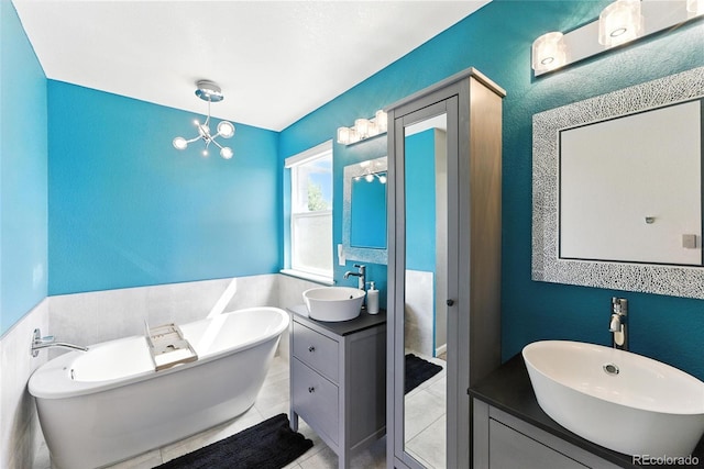 10116 Wyandott Cir, Denver, CO 80260 - bathroom with a freestanding bath, two vanities, a chandelier, and tile patterned floors