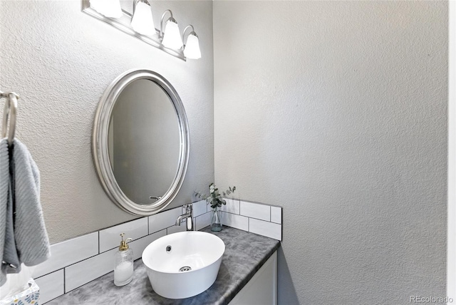 10116 Wyandott Cir, Denver, CO 80260 - bathroom with vanity, a textured wall, and decorative backsplash