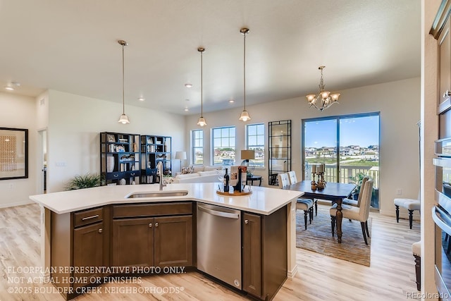 935 W 128th Pl, Westminster, CO 80234 - kitchen featuring appliances with stainless steel finishes, light countertops, light wood-style floors, decorative light fixtures, and recessed lighting