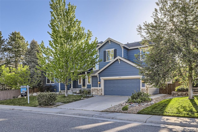 2660 Timberchase Trl, Highlands Ranch, CO 80126 - view of front facade featuring driveway, stone siding, and a garage