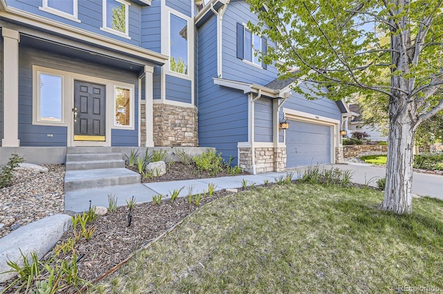 2660 Timberchase Trl, Highlands Ranch, CO 80126 - view of exterior entry featuring stone siding, driveway, and a garage