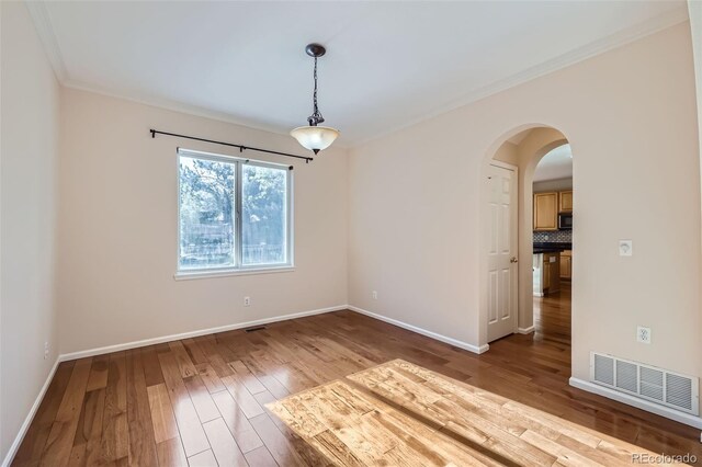 2660 Timberchase Trl, Highlands Ranch, CO 80126 - unfurnished room with crown molding, wood finished floors, baseboards, and arched walkways