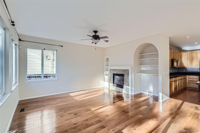 2660 Timberchase Trl, Highlands Ranch, CO 80126 - unfurnished living room with ceiling fan, light wood finished floors, baseboards, a premium fireplace, and recessed lighting