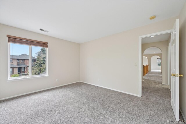 2660 Timberchase Trl, Highlands Ranch, CO 80126 - carpeted spare room featuring arched walkways, baseboards, and a smoke detector