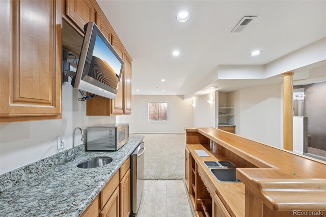 2660 Timberchase Trl, Highlands Ranch, CO 80126 - kitchen with stainless steel appliances, a sink, light stone countertops, open floor plan, and light colored carpet