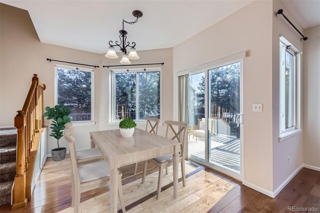 2660 Timberchase Trl, Highlands Ranch, CO 80126 - dining space with a chandelier, hardwood / wood-style flooring, baseboards, and stairs