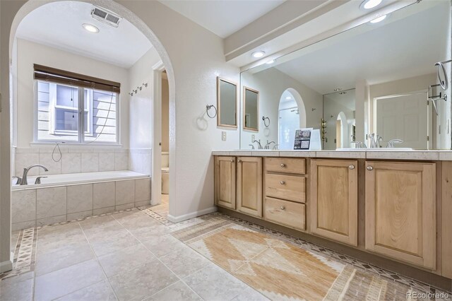 2660 Timberchase Trl, Highlands Ranch, CO 80126 - bathroom featuring toilet, a bath, double vanity, tile patterned flooring, and baseboards