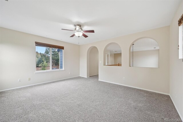 2660 Timberchase Trl, Highlands Ranch, CO 80126 - carpeted empty room with ceiling fan, baseboards, and arched walkways