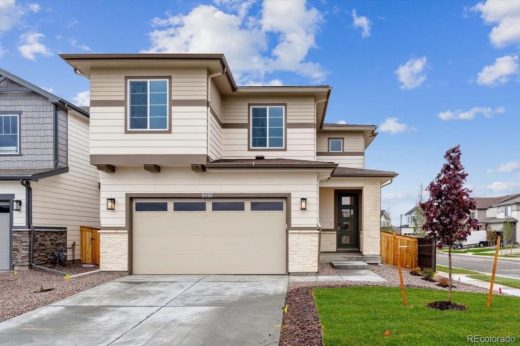 9297 Truckee Ct, Commerce City, CO 80022 - view of front facade featuring an attached garage and concrete driveway