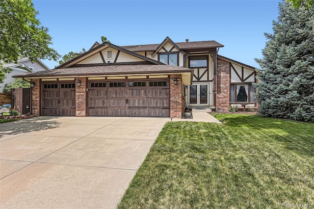 7863 W Friend Dr, Littleton, CO 80128 - english style home featuring a garage, a front lawn, driveway, brick siding, and french doors