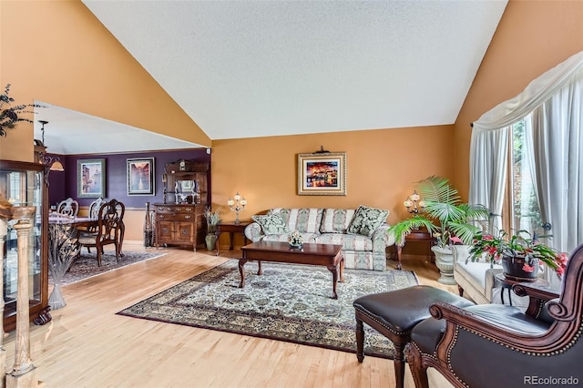 7863 W Friend Dr, Littleton, CO 80128 - living room featuring high vaulted ceiling and wood finished floors