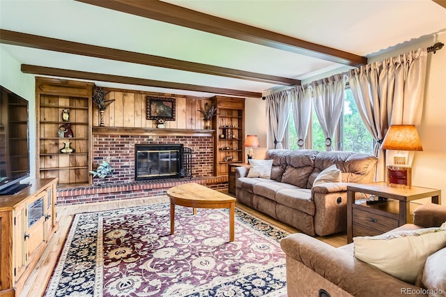 7863 W Friend Dr, Littleton, CO 80128 - living room featuring beamed ceiling, light wood-type flooring, and a fireplace