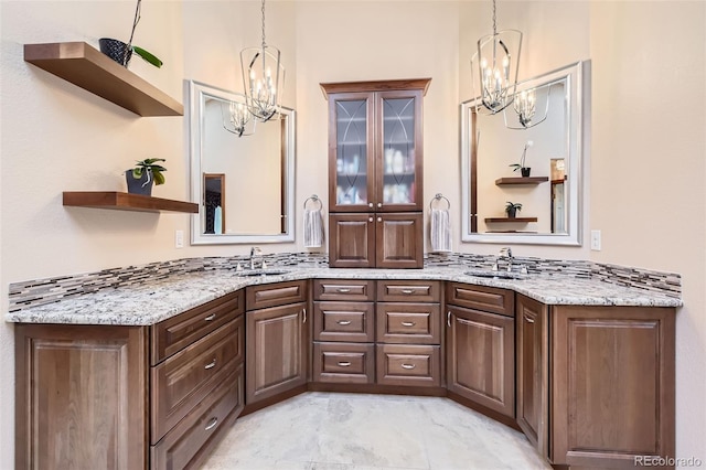 7863 W Friend Dr, Littleton, CO 80128 - bathroom featuring a chandelier, double vanity, and marble look tiles