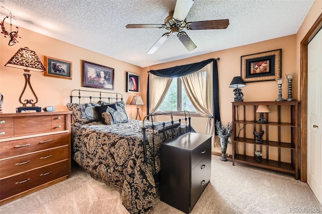 7863 W Friend Dr, Littleton, CO 80128 - bedroom with light colored carpet, a textured ceiling, and a ceiling fan