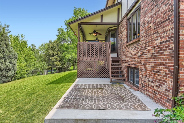 7863 W Friend Dr, Littleton, CO 80128 - property entrance featuring a lawn, brick siding, a ceiling fan, and a patio area