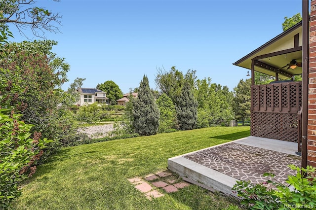 7863 W Friend Dr, Littleton, CO 80128 - view of grassy yard with ceiling fan and a patio area